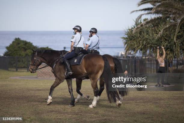 Mounted police officers patrol at Bondi Beach in Sydney, Australia, on Monday, Aug. 2, 2021. Sydneys lockdown has been extended three times times and...