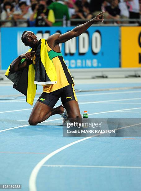 Jamaica's Usain Bolt strikes his trademark pose after winning gold in the men's 200 metres final at the International Association of Athletics...