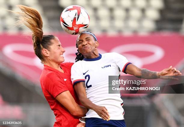 S defender Crystal Dunn vies for the header with Canada's forward Janine Beckie during the Tokyo 2020 Olympic Games women's semi-final football match...