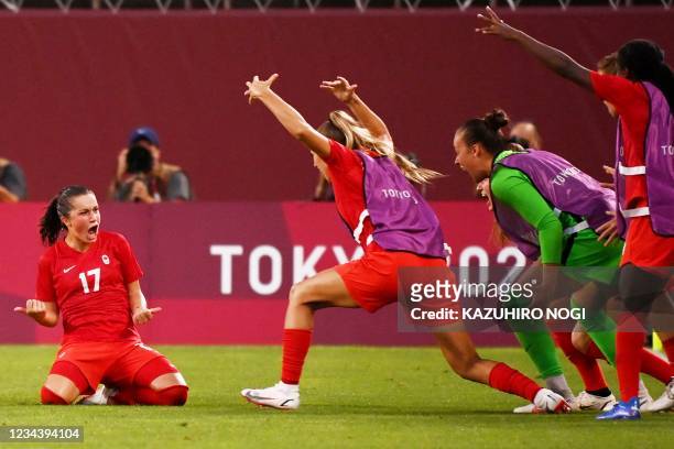 Canada's midfielder Jessie Fleming celebrates with teammates after scoring the opening goal during the Tokyo 2020 Olympic Games women's semi-final...
