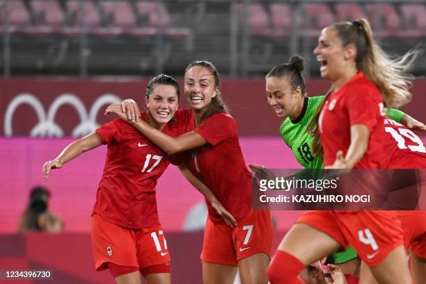 Canada's players celebrate their win in the Tokyo 2020 Olympic Games women's semi-final football match between the United States and Canada at...
