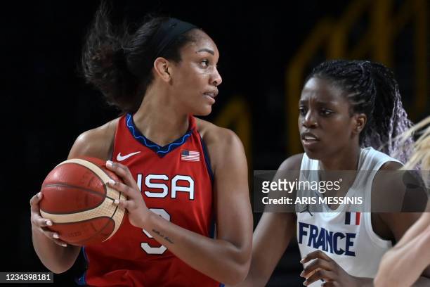 S A'ja Wilson handles the ball past France's Endene Miyem in the women's preliminary round group B basketball match between France and USA during the...