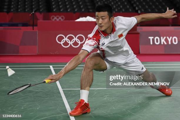 China's Chen Long hits a shot to Denmark's Viktor Axelsen in their men's singles badminton final match during the Tokyo 2020 Olympic Games at the...