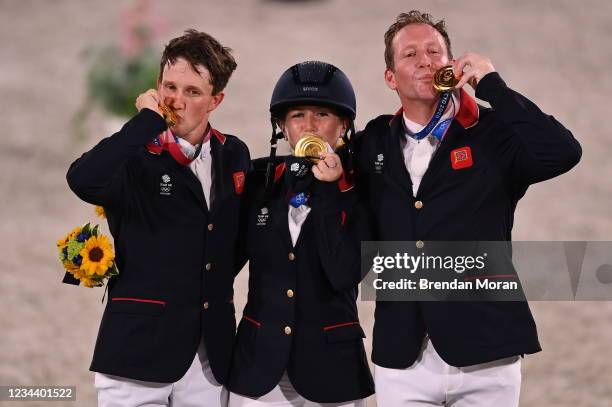 Tokyo , Japan - 2 August 2021; Team Great Britain members, from left, Tom McEwen, Laura Collett and Oliver Townend celebrate with their gold medals...