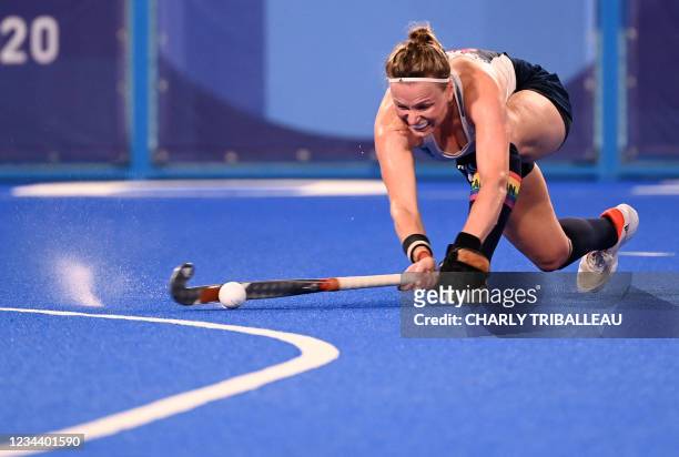 Britain's Hollie Pearne-Webb strikes the ball during the women's quarter-final match of the Tokyo 2020 Olympic Games field hockey competition against...