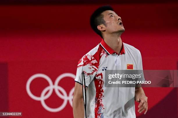 China's Chen Long reacts after a point with Denmark's Viktor Axelsen in their men's singles badminton final match during the Tokyo 2020 Olympic Games...