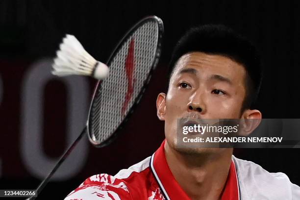 China's Chen Long hits a shot to Denmark's Viktor Axelsen in their men's singles badminton final match during the Tokyo 2020 Olympic Games at the...