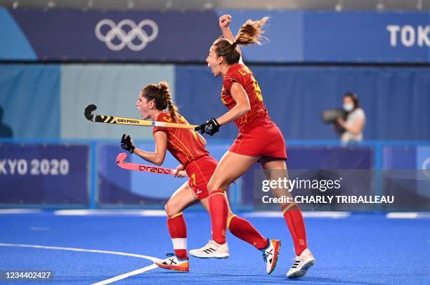 Spain's Carlota Petchame and Maria Lopez celebrate after teammate Belen Iglesias scored against Britain during their women's quarter-final match of...