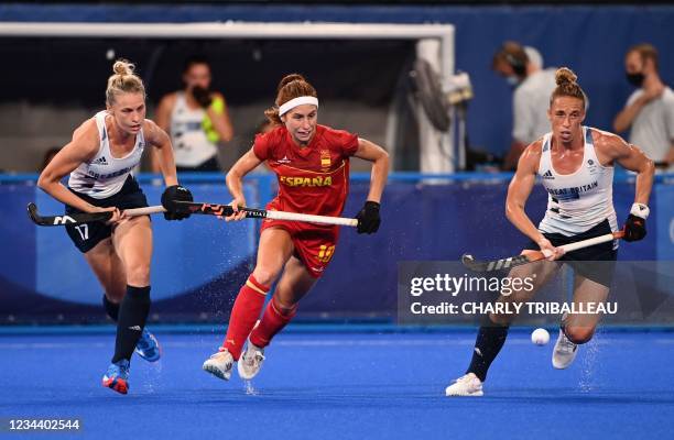 Spain's Begona Garcia and Britain's Leah Julia Wilkinson and Susannah Townsend run for the ball during their women's quarter-final match of the Tokyo...