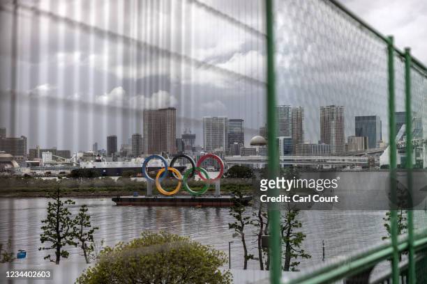 The Olympic Rings are seen through a security fence surrounding Odaiba Marine Park Olympic venue on August 2, 2021 in Tokyo, Japan. Despite a recent...