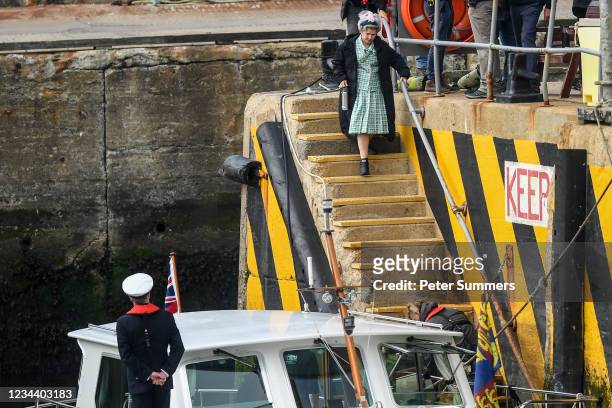 Imelda Staunton is seen walking to a boat made up to look like a Royal yacht tender in the harbour during filming for the Netflix series "The Crown"...