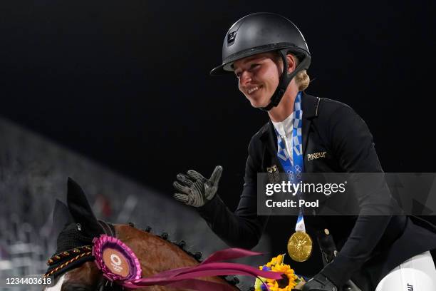 Gold medal winner Germany's Julia Krajewski rides in the ring after the equestrian event jumping individual final at Equestrian Park at the 2020...