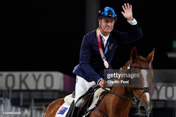 Australia's Andrew Hoy rides in the ring after receiving his bronze medal in the equestrian event jumping individual final at Equestrian Park at the...