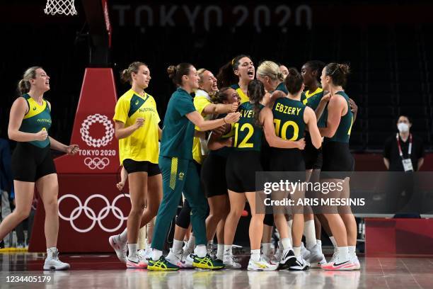 Australia's players celebrate their victory at the end of the women's preliminary round group C basketball match between Australia and Puerto Rico...