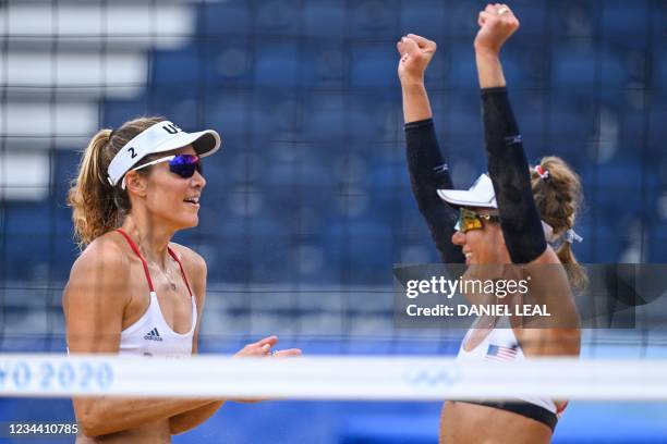 S Alix Klineman celebrates winning with partner April Ross after their women's beach volleyball quarter-final match between Germany and the USA...