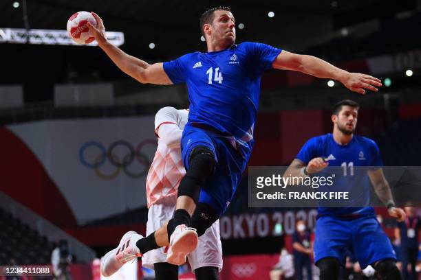 France's centre back Kentin Mahe jumps to shoot during the men's quarterfinal handball match between France and Bahrain of the Tokyo 2020 Olympic...