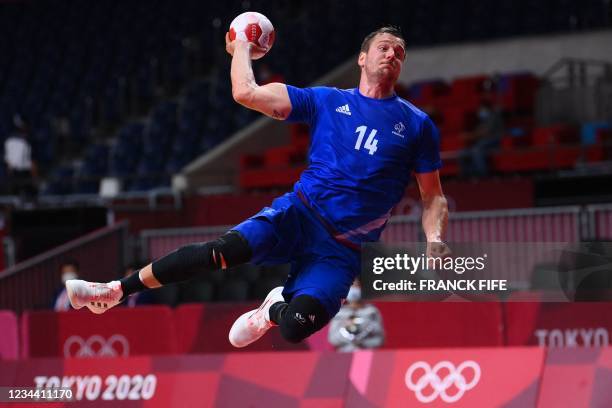 France's centre back Kentin Mahe jumps to score during the men's quarterfinal handball match between France and Bahrain of the Tokyo 2020 Olympic...