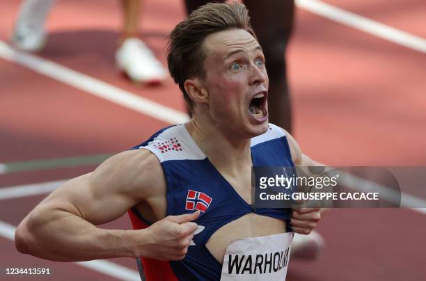 Norway's Karsten Warholm reacts after winning and breaking the world record in the men's 400m hurdles final during the Tokyo 2020 Olympic Games at...