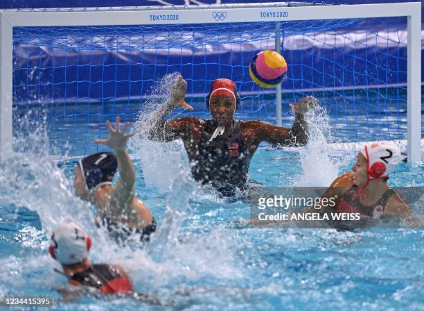 S Ashleigh Johnson concedes a goal from Canada's Shae La Roche during the Tokyo 2020 Olympic Games women's water polo quarter-final match between...