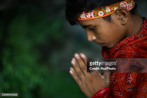 Hindu worshipper or pilgrim also called Bol Bom offer prayers as he walks towards a temple during the Hindu holy month of the Shrawan Sombar festival...