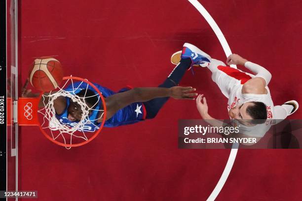 S Draymond Jamal Green goes to the basket past Spain's Victor Claver in the men's quarter-final basketball match between Spain and USA during the...