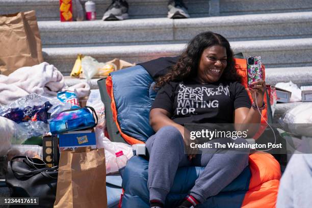 Representative Cori Bush livestreams with Netflix's Queer Eye star Jonathan Van Ness during a protest of the expiration of the federal eviction...