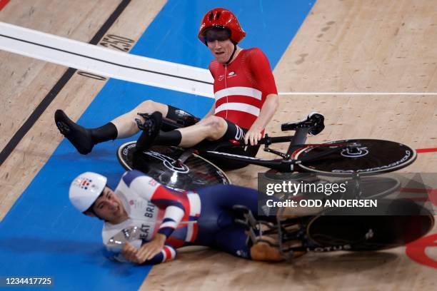 Denmark's Frederik Madsen crashes with Great Britain's Charlie Tanfiled during the first round heats of the men's track cycling team pursuit during...