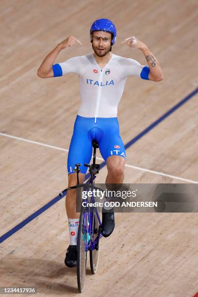 Italy's Filippo Ganna celebrates after setting the new world record during the first round heats of the men's track cycling team pursuit during the...