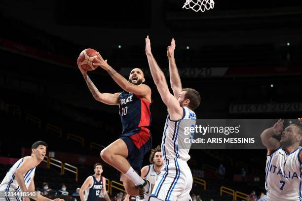 France's Evan Fournier goes to the basket past Italy's Nicolo Melli in the men's quarter-final basketball match between Italy and France during the...