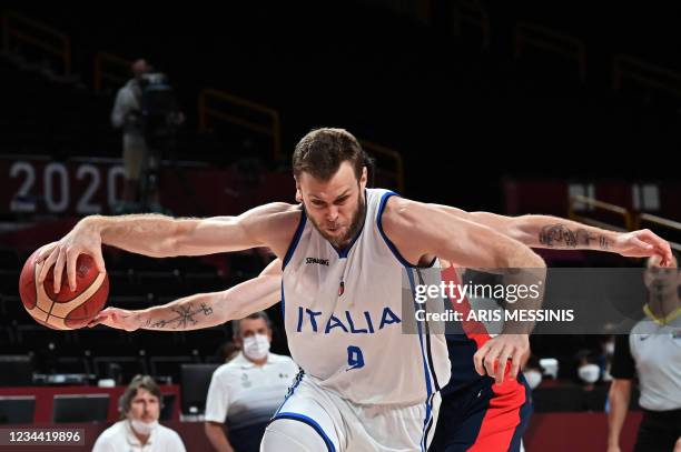 Italy's Nicolo Melli dribbles the ball past France's Nando De Colo in the men's quarter-final basketball match between Italy and France during the...