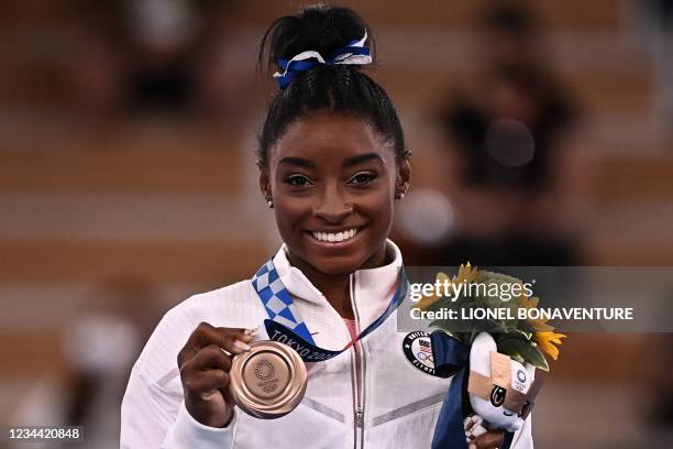 S Simone Biles poses with her bronze medal during the podium ceremony of the artistic gymnastics women's balance beam of the Tokyo 2020 Olympic Games...