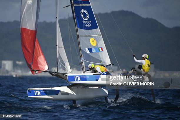 Italy's Ruggero Tita and Caterina Banti compete in the mixed multihull Nacra 17 foiling race during the Tokyo 2020 Olympic Games sailing competition...