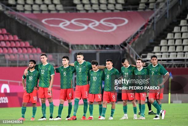 Mexico's players watch the penalty shoout out during the Tokyo 2020 Olympic Games men's semi-final football match between Mexico and Brazil at...