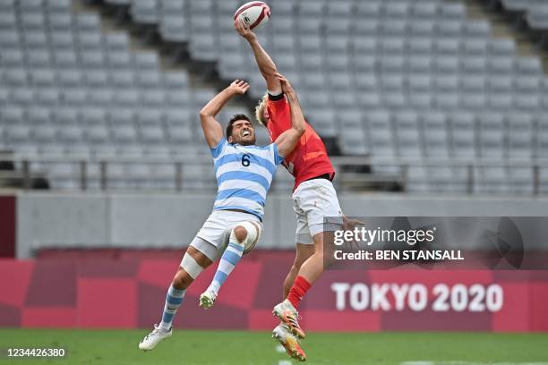 Argentina's Santiago Alvarez and Britain's Ben Harris jump for the ball in the men's bronze medal rugby sevens match between Britain and Argentina...