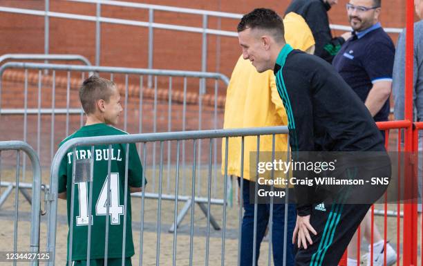 David Turnbull is pictured with a young supporter as Celtic depart for their Europa League tie against Jablonec, at Celtic Park, on August 03 in...