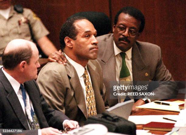 Lead defense attorney Johnnie Cochran puts his arm on O.J. Simpson's shoulder after Simpson told Judge Lance Ito 22 September 1995 in Los Angeles,...