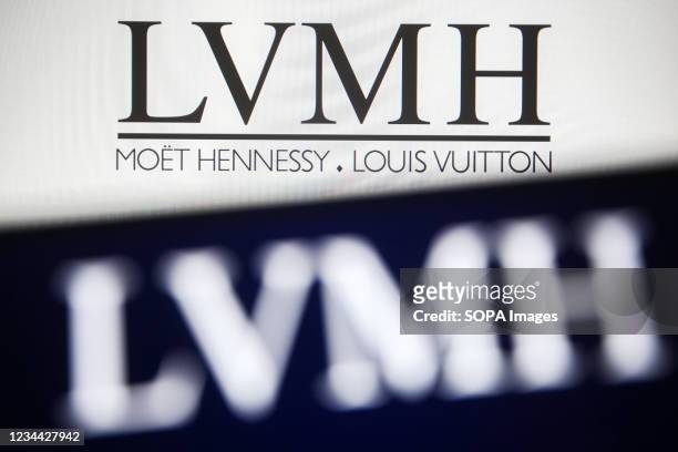 In this photo illustration a LVMH logo is seen on a smartphone and