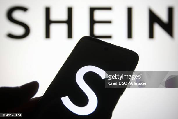 In this photo illustration a Shein logo of a Chinese online fashion and sports retailer is seen on a smartphone and a pc screen.
