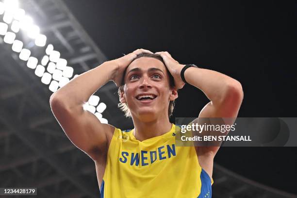 Sweden's Armand Duplantis celebrates as he competes in the men's pole vault final during the Tokyo 2020 Olympic Games at the Olympic Stadium in Tokyo...