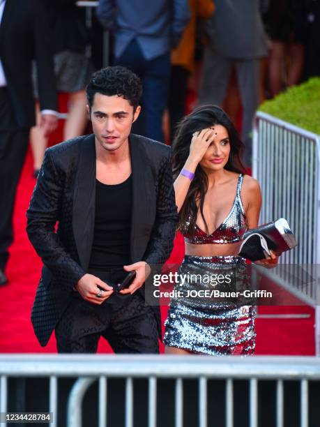 Darren Barnet and Mikaela Hoover are seen outside 'The Suicide Squad' Premiere at Bruin Theatre on August 02, 2021 in Los Angeles, California.