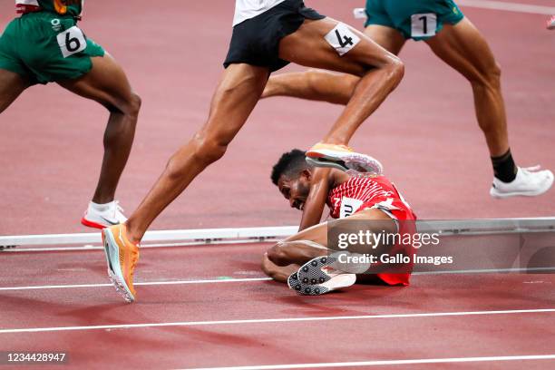 Dawit Fikadu of Bahrain falls on the track as the other athletes run over him in the heats of the mens 5000m during the evening session of the...