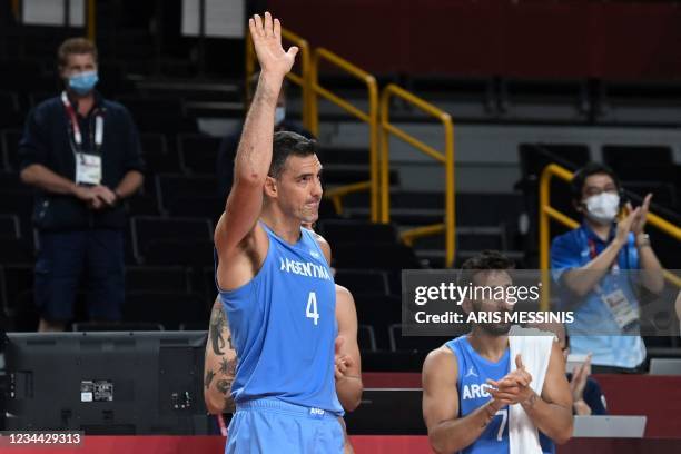 Argentina's Luis Scola gestures as Argentina's and Australia's players applaud at the end of the men's quarter-final basketball match between...