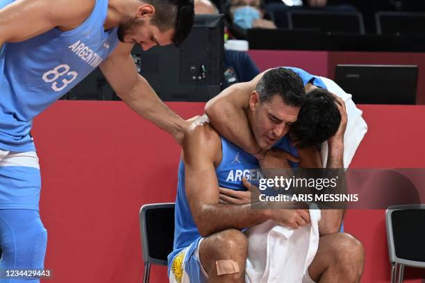 Argentina's Luis Scola is comforted by teammates at the end of the men's quarter-final basketball match between Australia and Argentina during the...