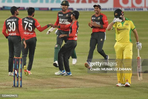 Bangladesh's cricketers celebrate after the dismissal of Australia's Moises Henriques during first Twenty20 international cricket match between...