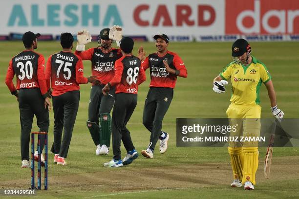 Bangladesh's cricketers celebrate after the dismissal of Australia's Moises Henriques during first Twenty20 international cricket match between...