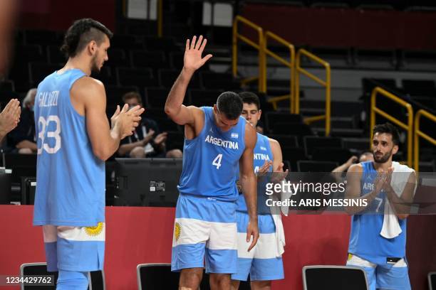 Argentina's Luis Scola gestures as Argentina's and Australia's players applaud at the end of the men's quarter-final basketball match between...