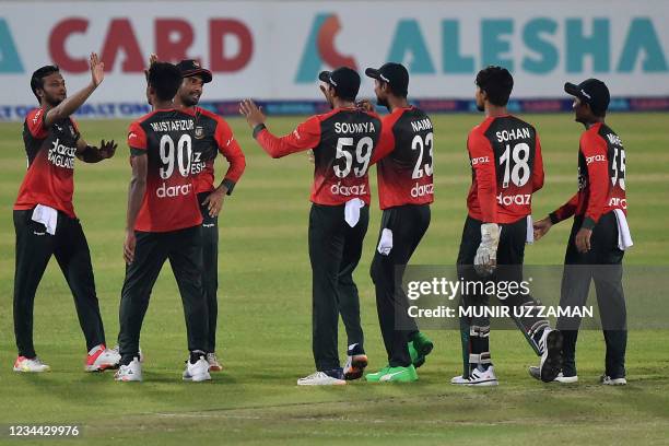 Bangladesh's cricketers celebrate their win in the first Twenty20 international cricket match against Australia at the Sher-e-Bangla National Cricket...