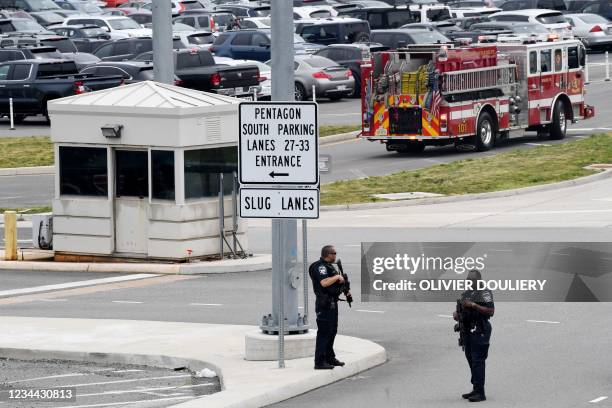 Law enforcement officers are seen near the entrance of the Pentagon after a report of an active shooter and lockdown in Washington, DC on August 3,...