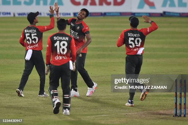 Bangladesh's cricketers celebrate their win in the first Twenty20 international cricket match against Australia at the Sher-e-Bangla National Cricket...