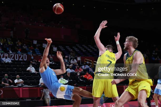 Argentina's Luis Scola shoots the ball past Australia's Joe Ingles in the men's quarter-final basketball match between Australia and Argentina during...